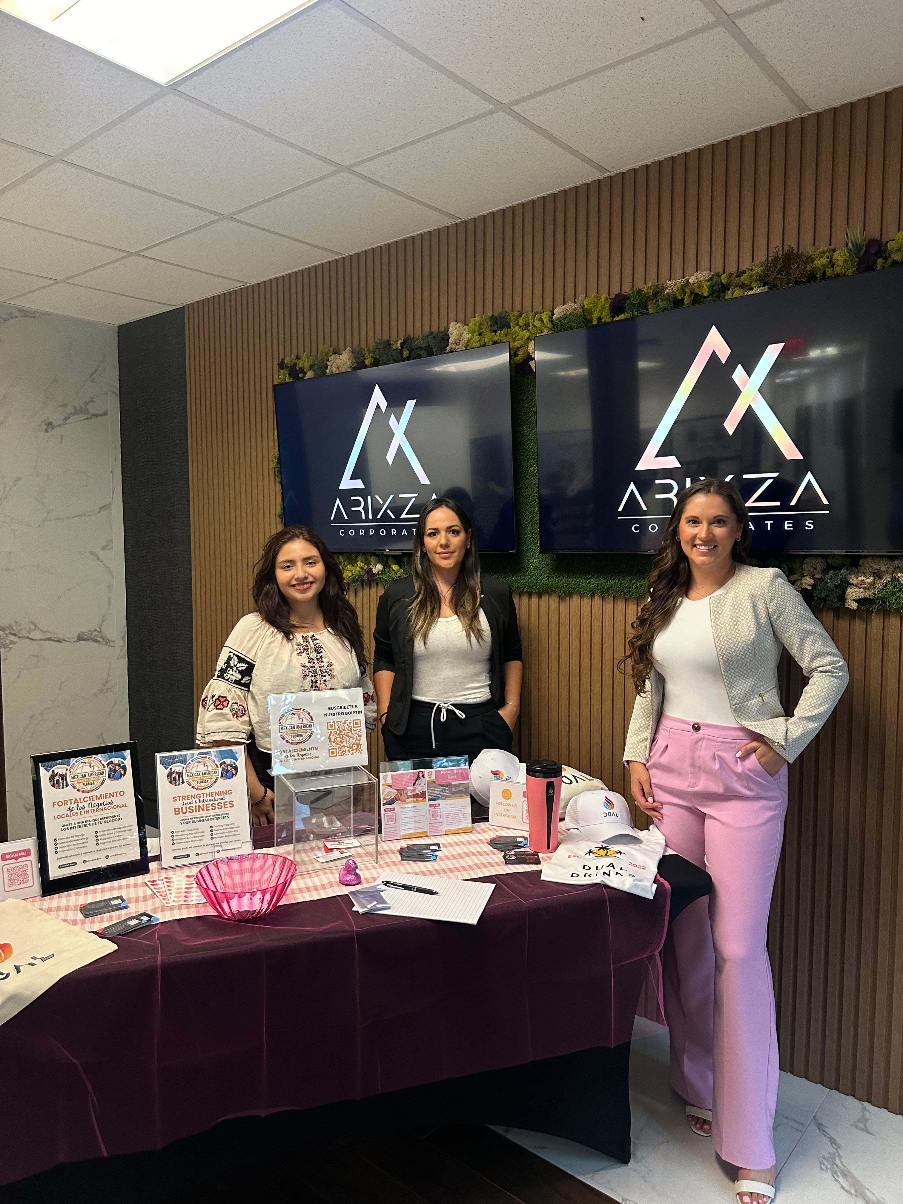 3 women posing together in front of a professional booth